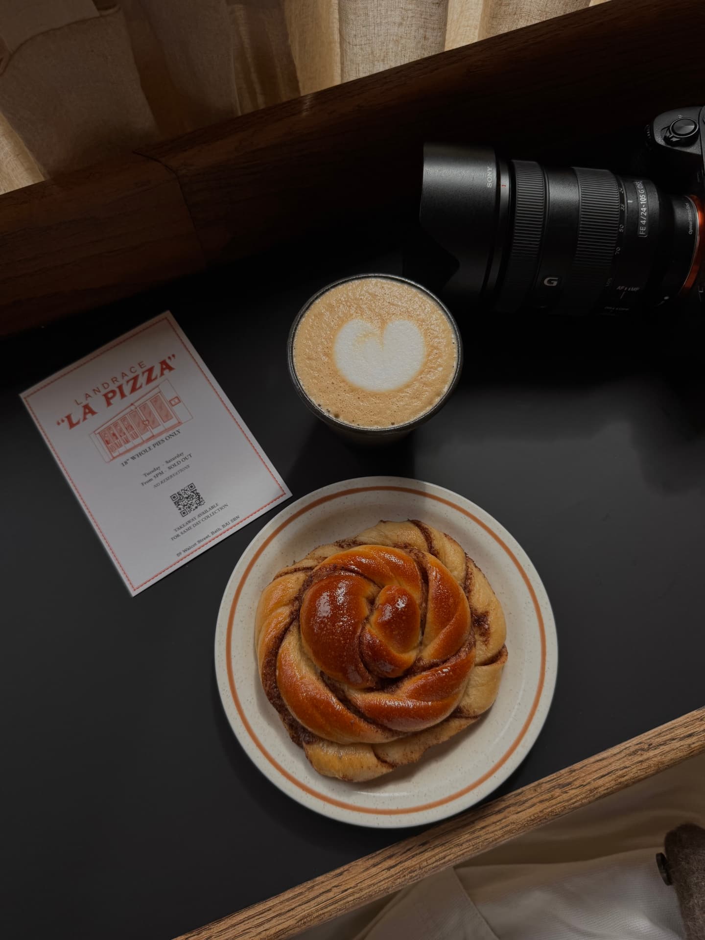 Camera, coffee and pastry on a cafe table